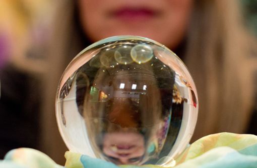 Eine Wahrsagerin blickt auf der Esoterik-Messe in Stuttgart in eine Kristallkugel (Symbolbild) Foto: dpa/Sebastian Kahnert
