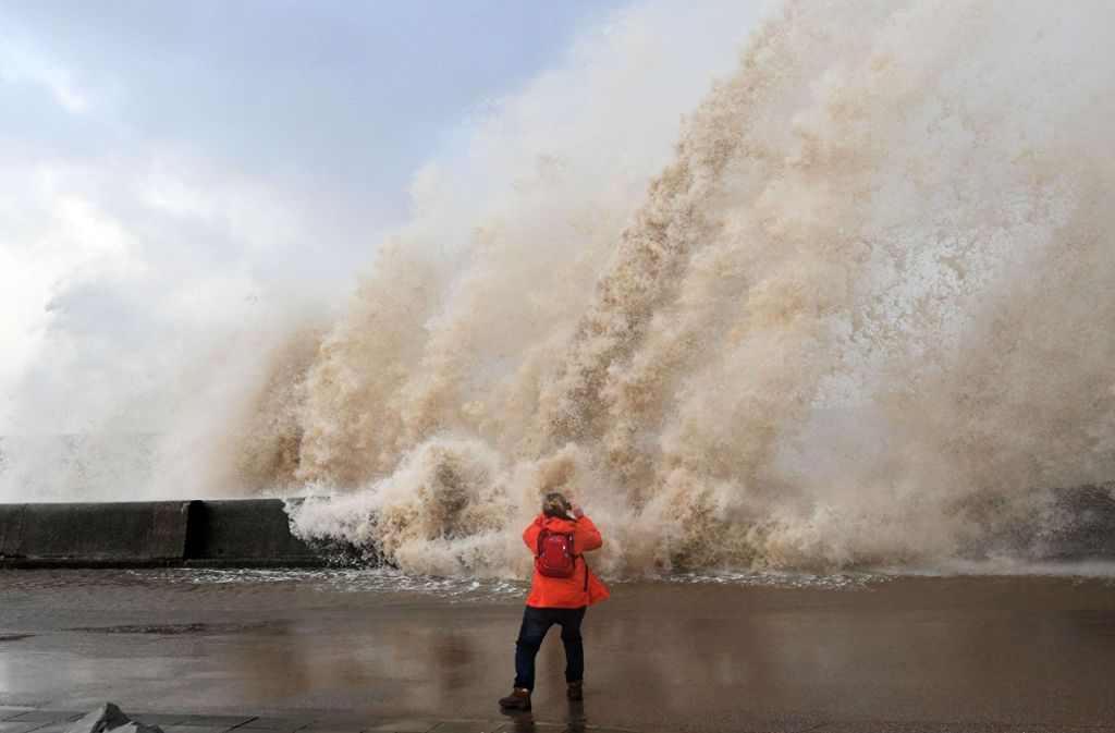 Gefährlich nah steht diese Frau in New Brighton, nördwestlich von England, an den Wellen, um sie zu fotografieren.
