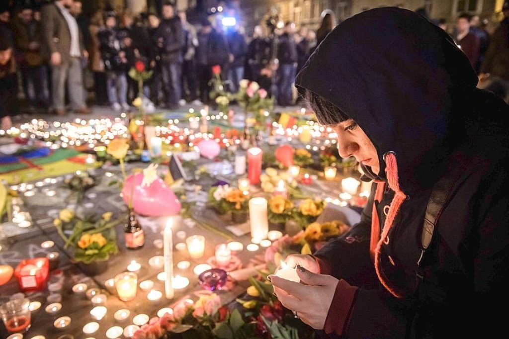 Menschen gedenken der Opfer der Terroranschläge von Brüssel am Platz der Börse.