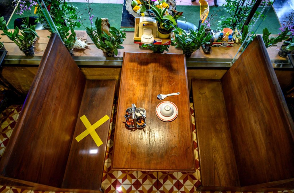 Noch ein Beispiel aus Thailand: Auf dem bei Touristen beliebten Chatuchak-Markt in Bangkok markiert an diesem Tisch ein gelbes Kreuz, welcher Platz leer bleiben soll.