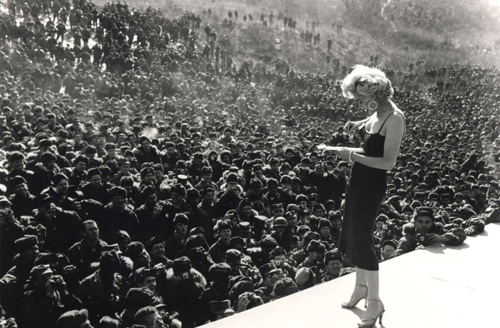 1954 singt Schauspielerin Marilyn Monroe für die amerikanischen Soldaten in Korea. Hier signiert sie während der Show Autogramme.