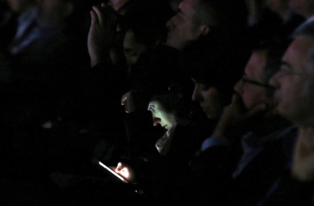 Kürzlich beim Mobile World Congress in Barcelona: statt dem WhatsApp-Gründer Jan Koum zuzuhören, widmet sich eine Frau im Publikum lieber ihrem Smartphone. Foto: dpa
