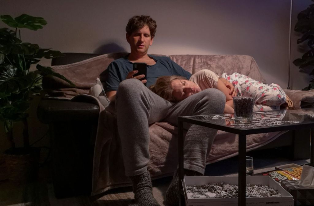 Szenenfoto aus „Liebe. Jetzt!“: Heiner (Sebastian Schwarz) und seine Ehefrau Marie (Marie Burchard), während sie schläft, chattet er mit seiner Arbeitskollegin.