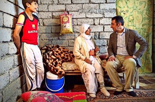 Cem Özdemir (rechts) sucht das Gespräch mit Flüchtlingen. Viele leben in Rohbauten. Foto: Knut Krohn