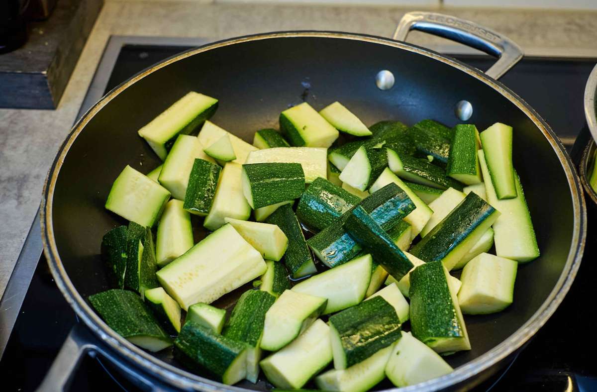 Das Bratöl in einer Pfanne erhitzen, die Zucchinispalten darin etwa 5 Minuten scharf anbraten und mit Salz würzen.