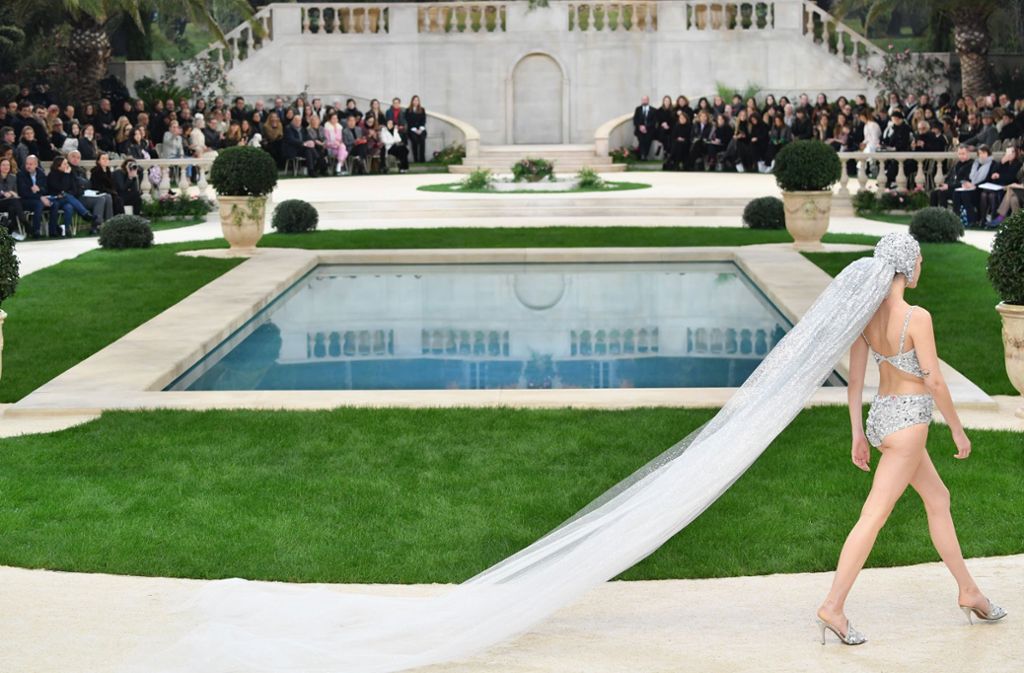 Während draußen eisige Kälte herrschte, liefen Chanels Models im Grand Palais vor der Kulisse einer italienischen Luxusvilla um einen Swimmingpool herum.