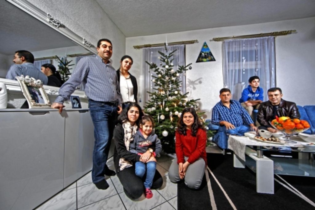 Weihnachten gibt es bei Jesiden nicht, einen Christbaum hat die Familie   dennoch:  Ahmed   Kurt (links)  mit seiner Frau, den vier Kindern und den Freunden Hassan Dnanie (auf dem Sofa links) und Khairi Blasini Foto: Gottfried Stoppel