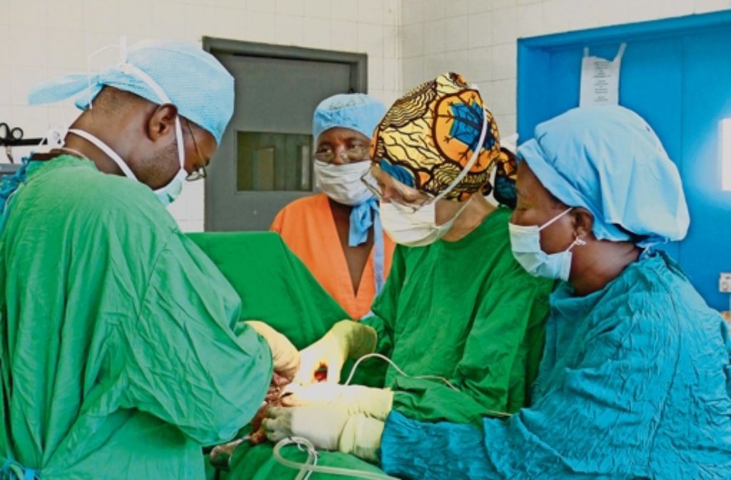 Die Chirurgin Sabine Waldmann-Brun bei einer Operation in Sierra Leone, links zu sehen ist ein chirurgischer Auszubildender. Weitere Eindrücke gibt es in unserer Fotostrecke.