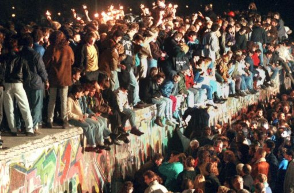 Auf der Berliner Mauer knallen die Korken, fließen die Freudentränen - und die DDR-Grenzer schauen zu. Manch einer dürfte sich perplex die Augen gerieben haben, über das deutsch-deutsche Wunder, das sich in dieser Nacht vollzieht.