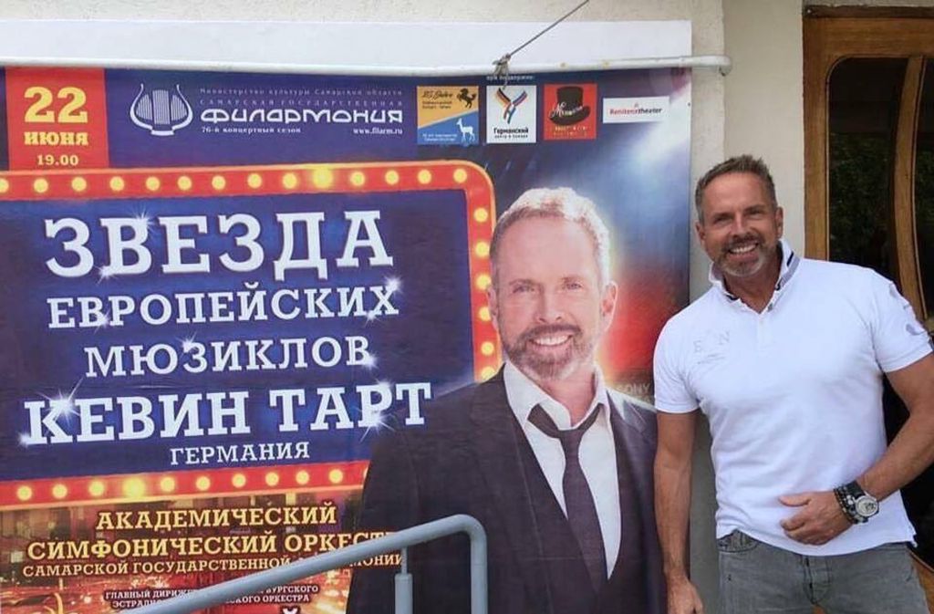 Musicalstar Kevin Tarte vor seinem Plakat in Samara.
