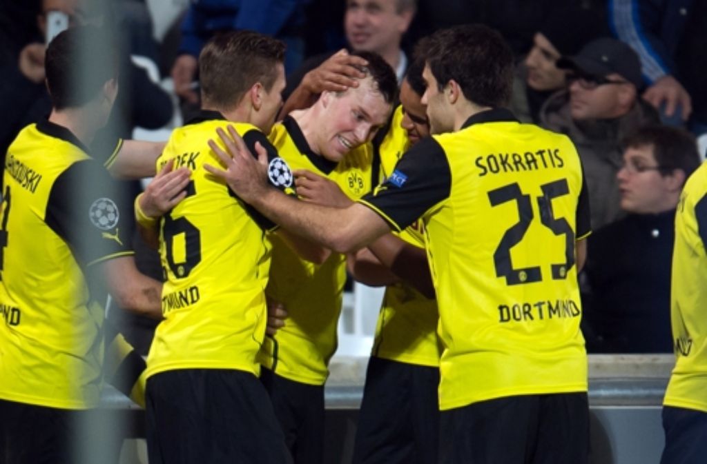 Glücksmoment: die Dortmunder herzen den Siegtorschützen Kevin Großkreutz (Mitte) Foto: AFP