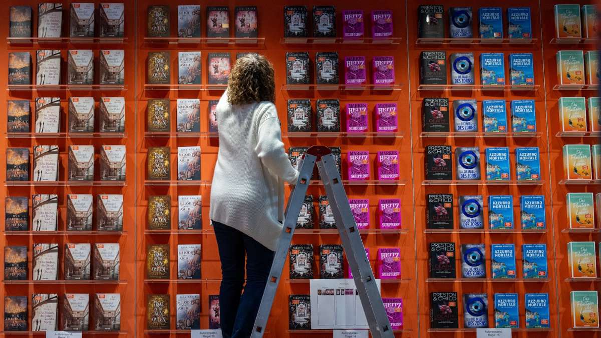 Eine Mitarbeiterin bestückt einen Stand auf der Leipziger Buchmesse. Ab dem 21. März präsentieren 2000 Aussteller aus 40 Ländern ihre Neuheiten auf der Messe in Leipzig.