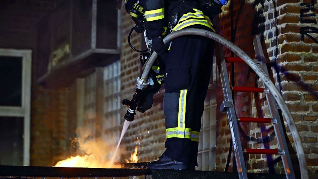 Ein Anbau mit Müllmaterial geht mitten in der Nacht in Flammen auf. Die Feuerwehr kann ein Übergreifen auf ein Wohn- und Geschäftshaus verhindern. 