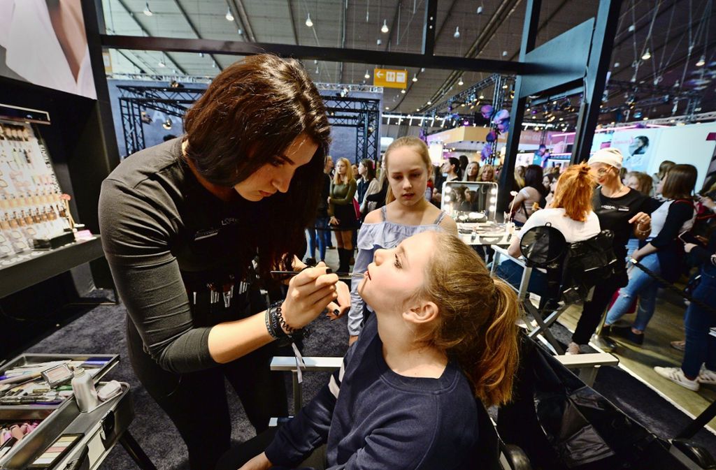 Die elfjährige Zoe lässt sich von einer Visagistin schminken, ihre Freundin Katie schaut zu. Foto: Oliver Willikonsky - Lichtgut