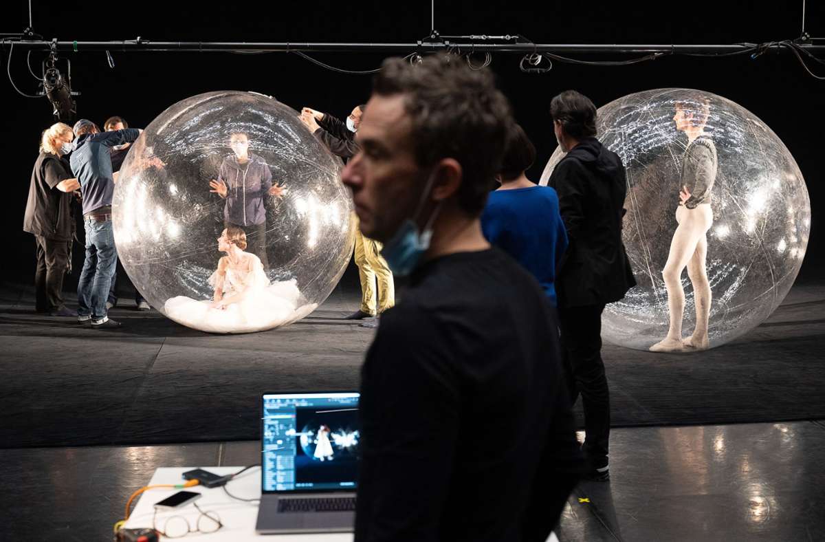 Der Künstler Florian Mehnert (vorn) packt mit seinem Team zwei Solisten des Stuttgarter Balletts in transparente Plastikkugeln.