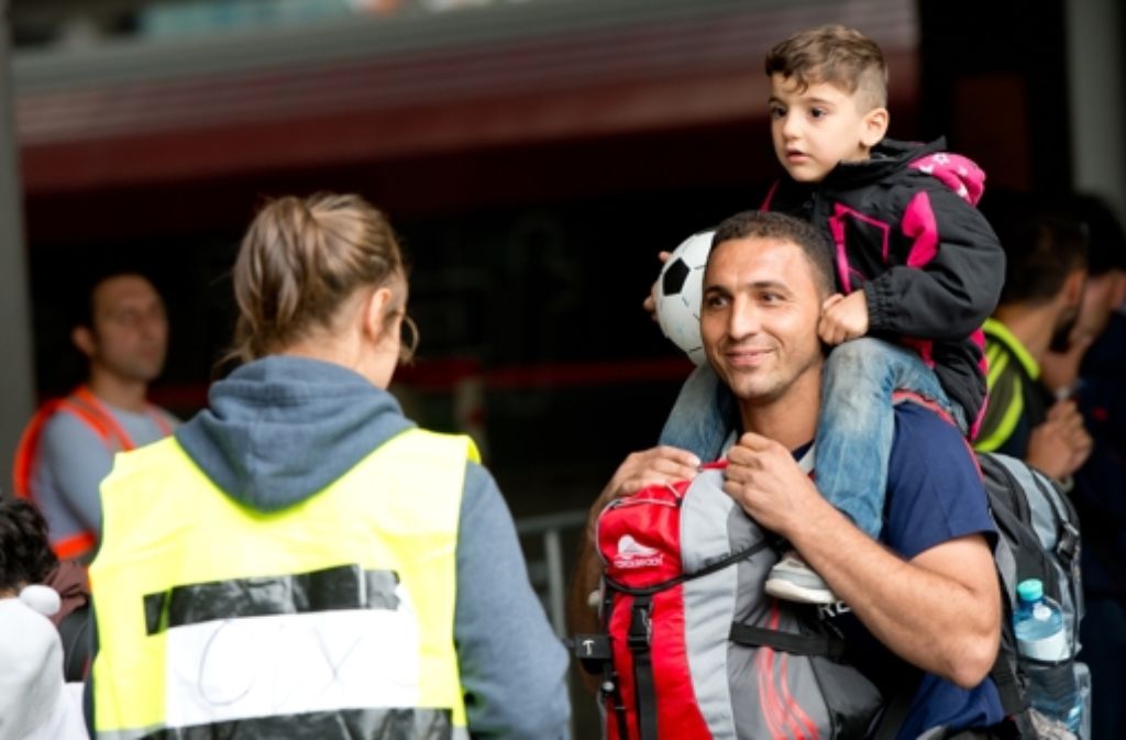 München: Freiwillige Helfer begrüßen Flüchtlinge.