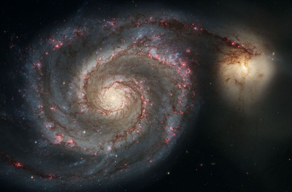 Die Whirlpool-Galaxie (M51a) und die Begleitgalaxie (M51b). Dieses Hubble-Weltraumteleskopbild stellt eine Verschmelzung zweier Galaxien dar, die in der Masse der Milchstraße und der großen Magellanschen Wolke ähneln.