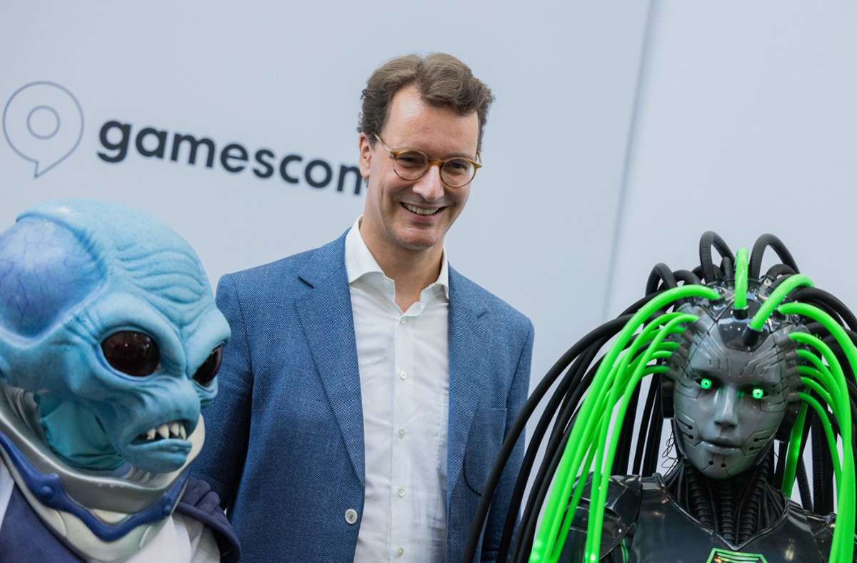 Hendrik Wüst (CDU), Ministerpräsident von Nordrhein-Westfalen, steht zwischen Cosplayern auf der Gamescom in Köln. Foto: dpa/Rolf Vennenbernd