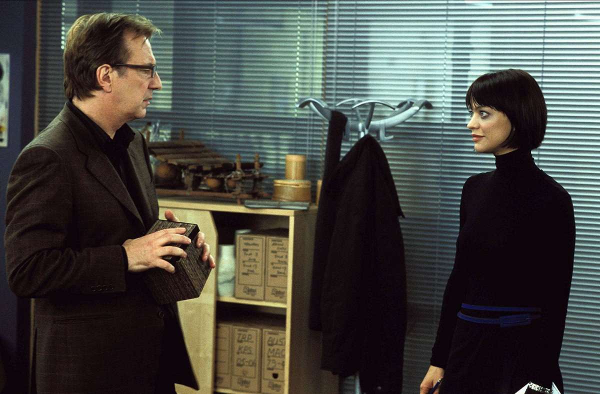 Karens Mann Harry (Alan Rickman, der leider 2016 an Krebs verstarb) flirtet mit seiner Assistentin Mia (Heike Makatsch).