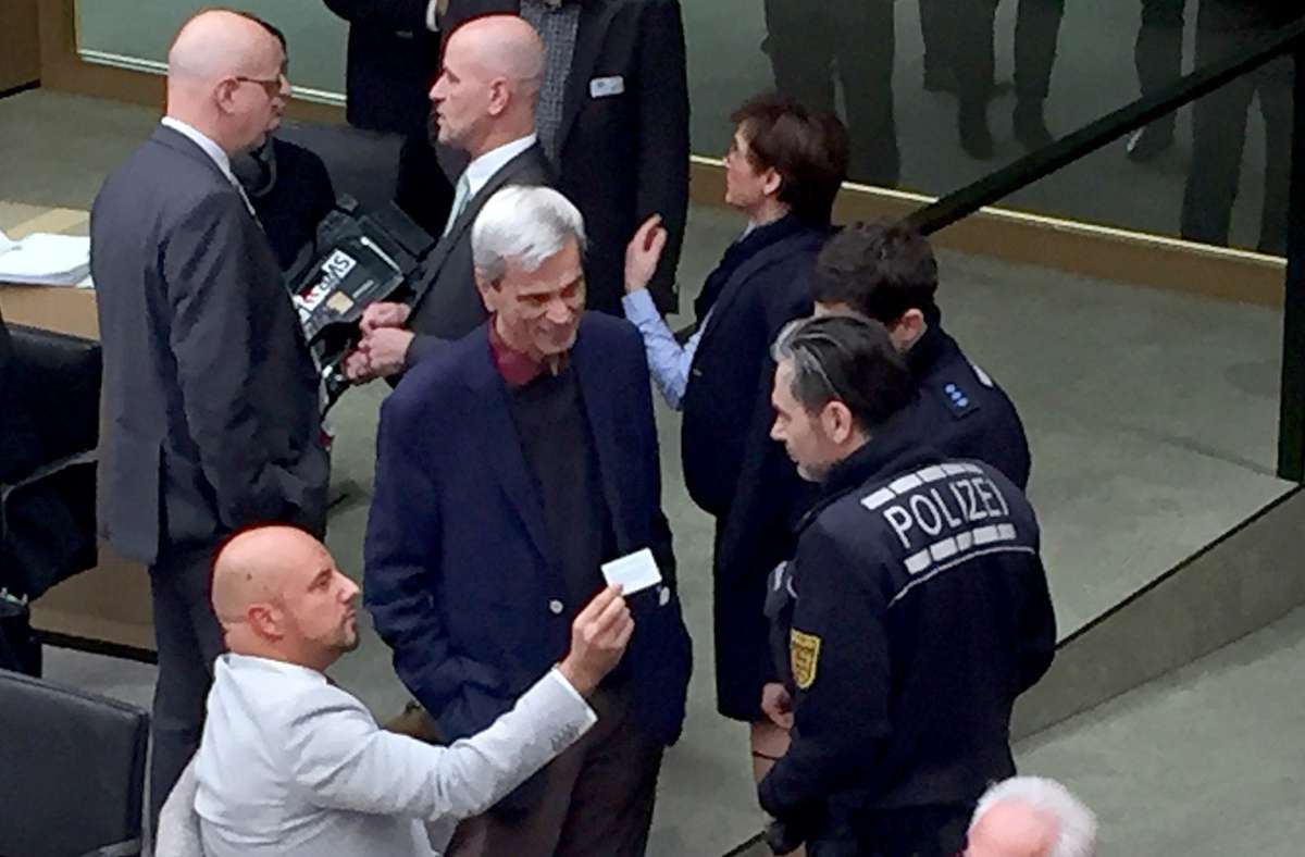 Der Abgeordnete Stefan Räpple (AfD, vorne) wird von zwei Polizisten im Landtag beäugt. Neben ihm steht der Abgeordnete Wolfgang Gedeon.