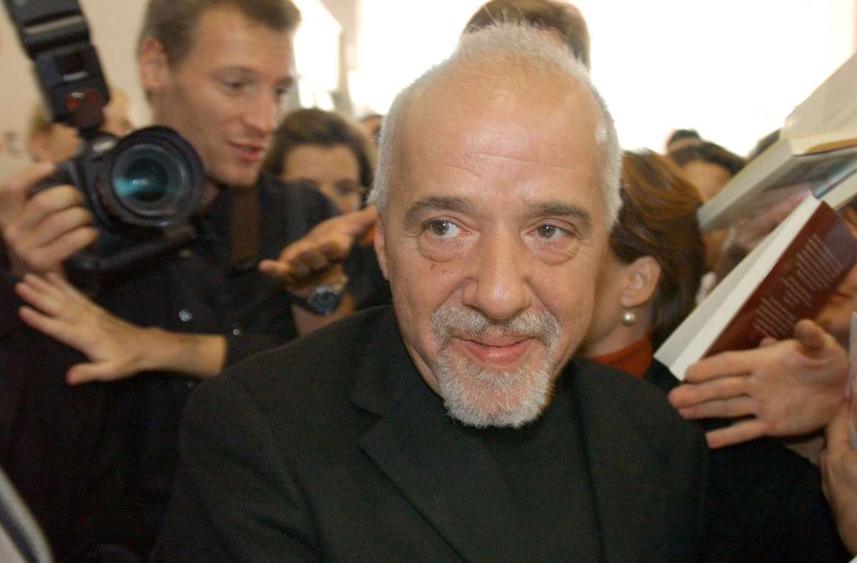 Umringt von Fans und Autogrammjägern bahnt sich der brasilianische Bestseller-Auto Paulo Coelho 2003 auf der Frankfurter Buchmesse einen Weg.