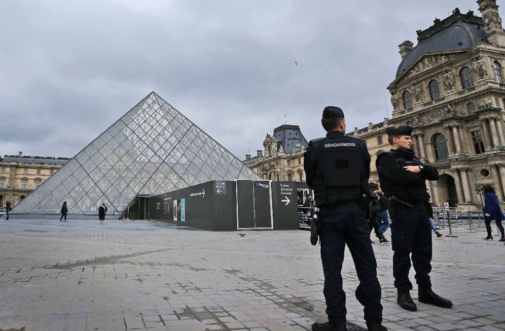 Polizisten stehen vor dem Louvre in Paris.