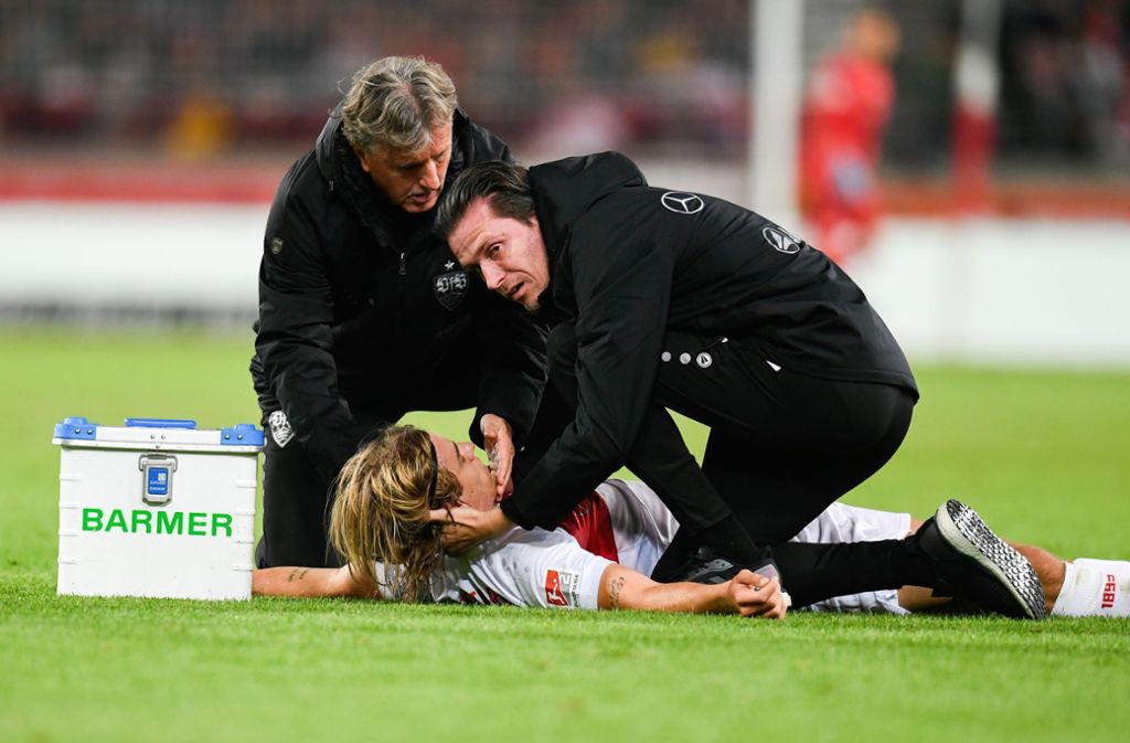 Borna Sosa vom VfB Stuttgart wird von den Mannschaftsärzten behandelt.