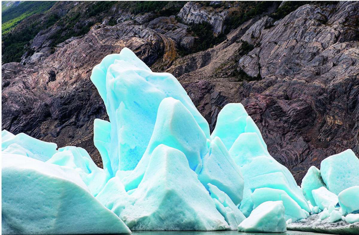 Saphirblaues Eis im Meer vor dunklem Fels: der Grey-Gletscher im chilenischen Patagonien.