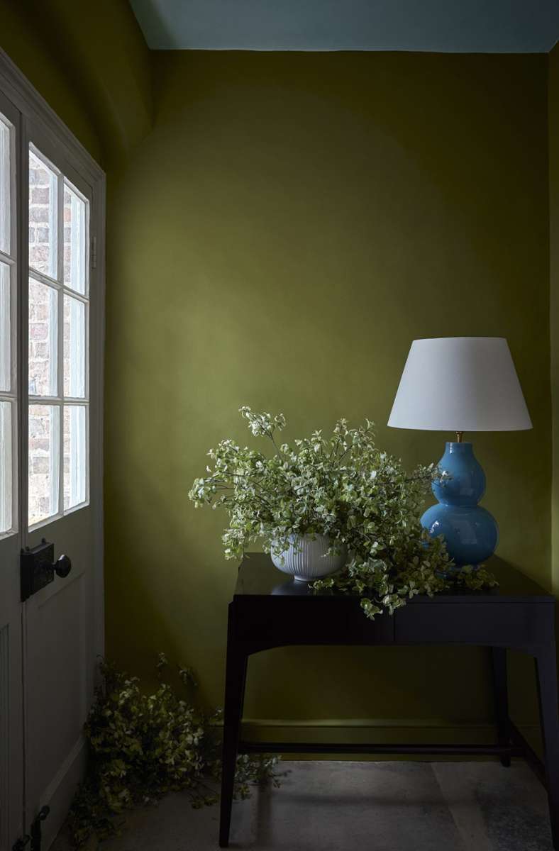 Dunkelheit schön inszeniert: Grüne Wand und blauer Vasenfuß.
