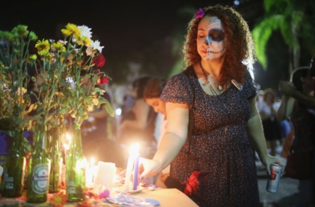 Statt einer tristen Trauerveranstaltung ist der 1.November auch in Rio ein Tag, an dem mit Musik, Drinks, Blumen und viel Schminke zu Ehren der Toten gefeiert wird.