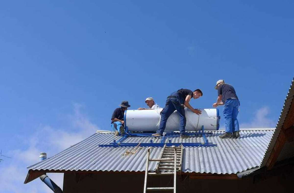 Die Solaranlage wird auf dem Dach des Schulhauses montiert.